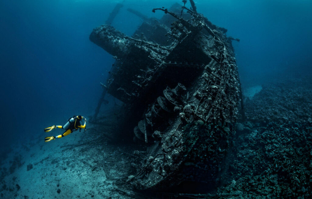 The wreck of the Nuestra Señora de Atocha lying on the ocean floor, surrounded by coral and marine life