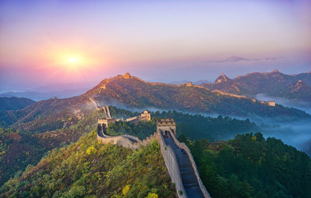 A detailed view of the Great Wall of China, snaking along a rugged mountain range, representing ancient Chinese fortifications