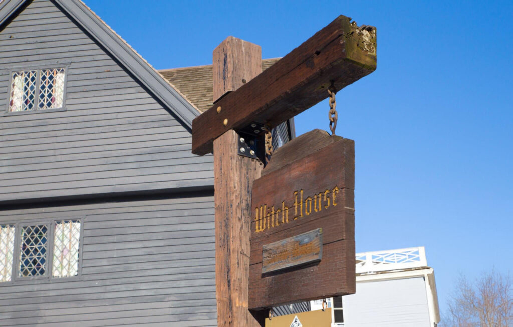 "View of the historic Salem Witch House, a dark, gabled wooden structure that once belonged to Judge Jonathan Corwin, who presided over the Salem Witch Trials."

